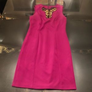 Pink sleeveless midi with a bold statement collar